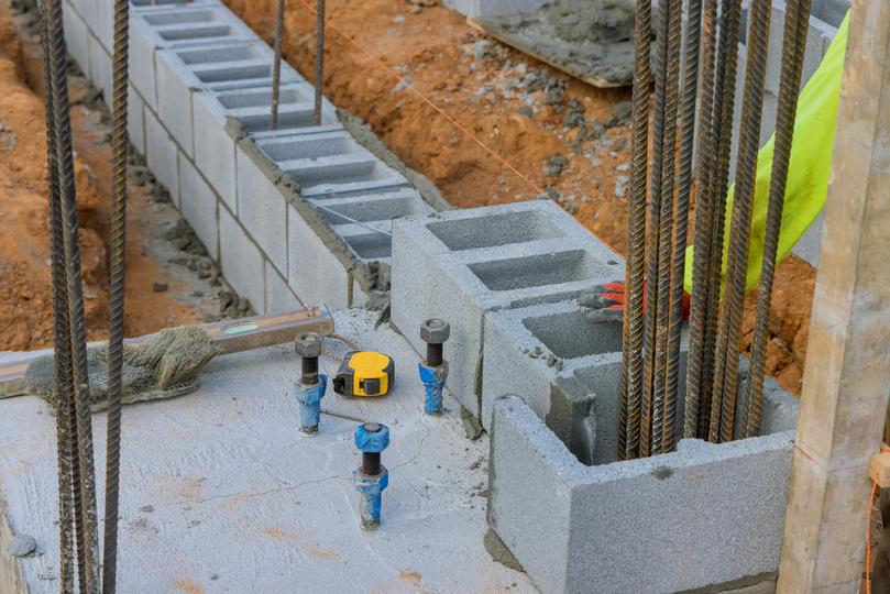 A concrete retaining wall in a landscaped garden