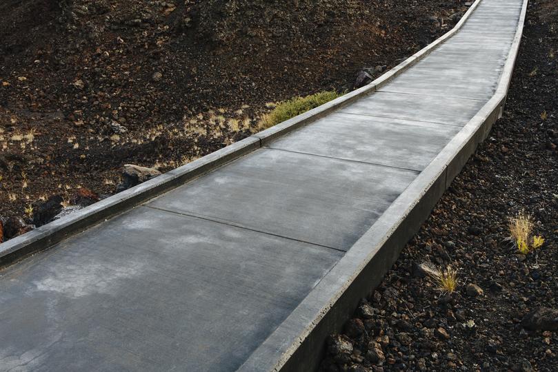 A newly installed concrete curb along a residential street