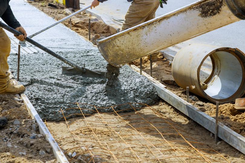 A Concrete truck pouring a foundation