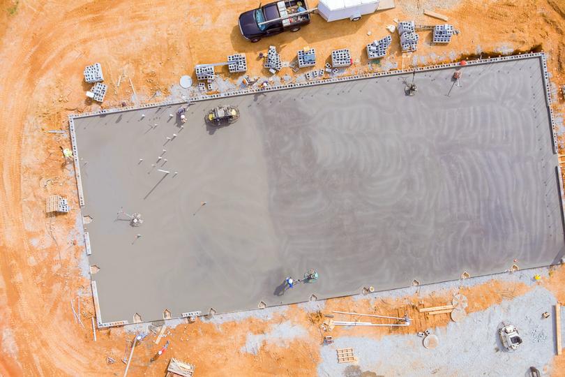 A large concrete parking lot with clearly marked spaces