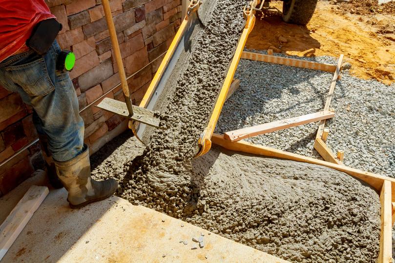 A Concrete truck pouring a foundation