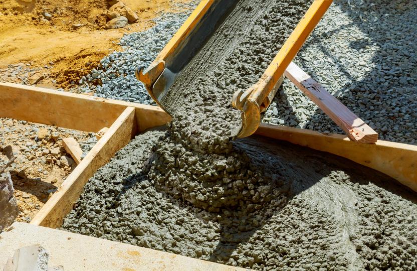 A Concrete truck pouring a foundation