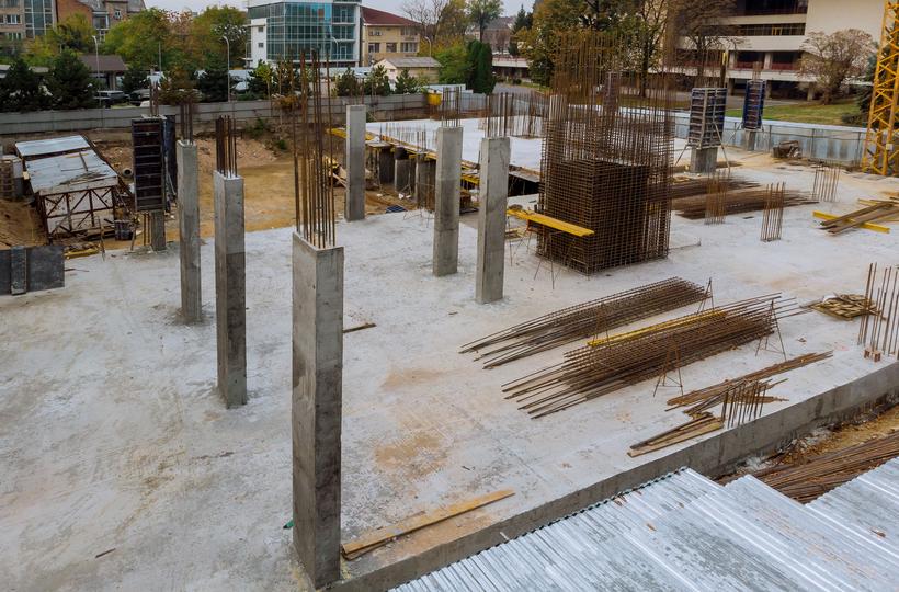 Construction workers pouring concrete for a foundation