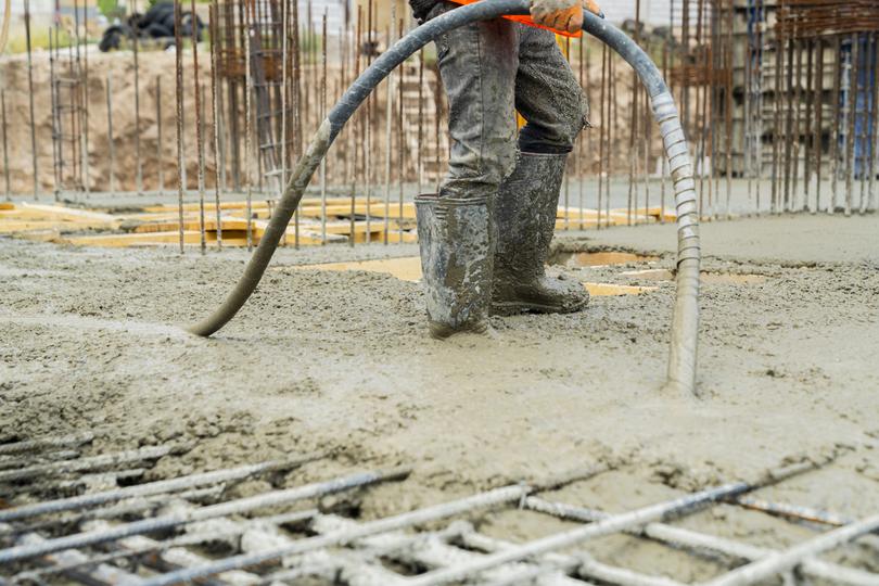 Concrete pump delivering concrete to a hard-to-reach area