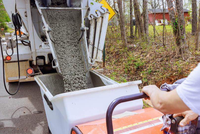 A Concrete truck pouring a foundation