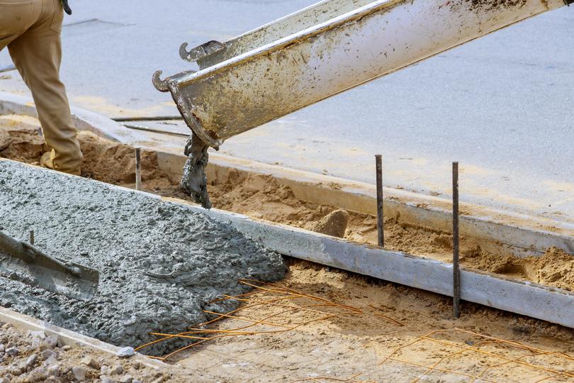 A Concrete truck pouring a foundation