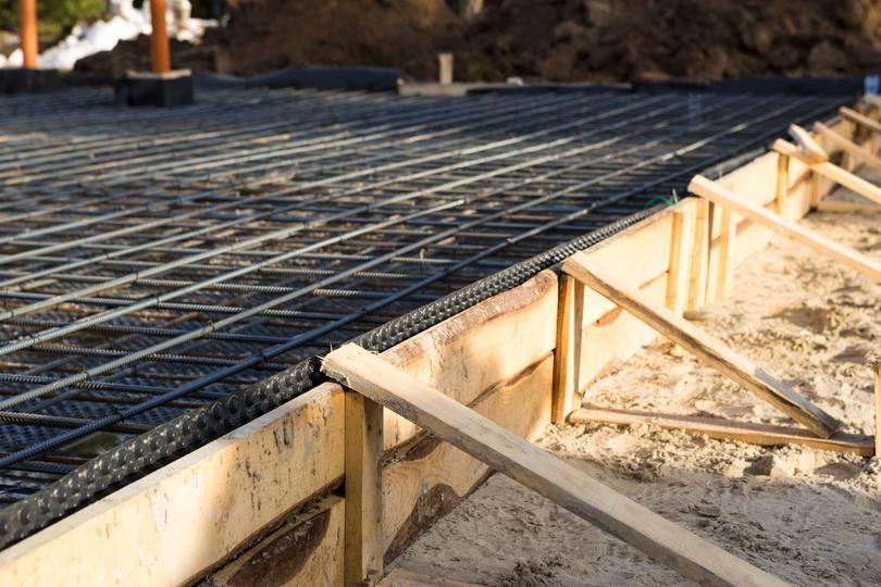 Construction workers pouring concrete for a foundation