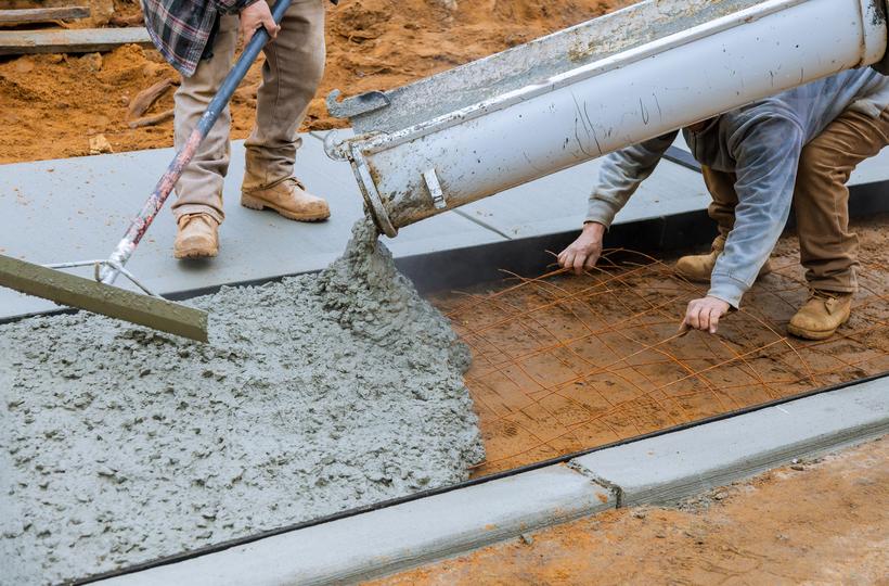 A Concrete truck pouring a foundation