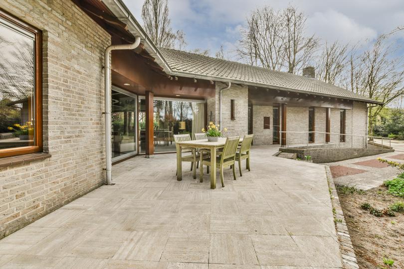 A modern concrete patio with stylish furniture