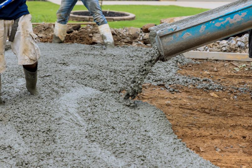 A Concrete truck pouring a foundation