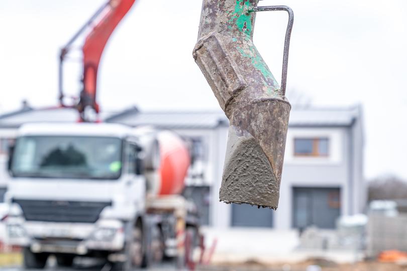 Concrete mixer truck delivering concrete to a construction site