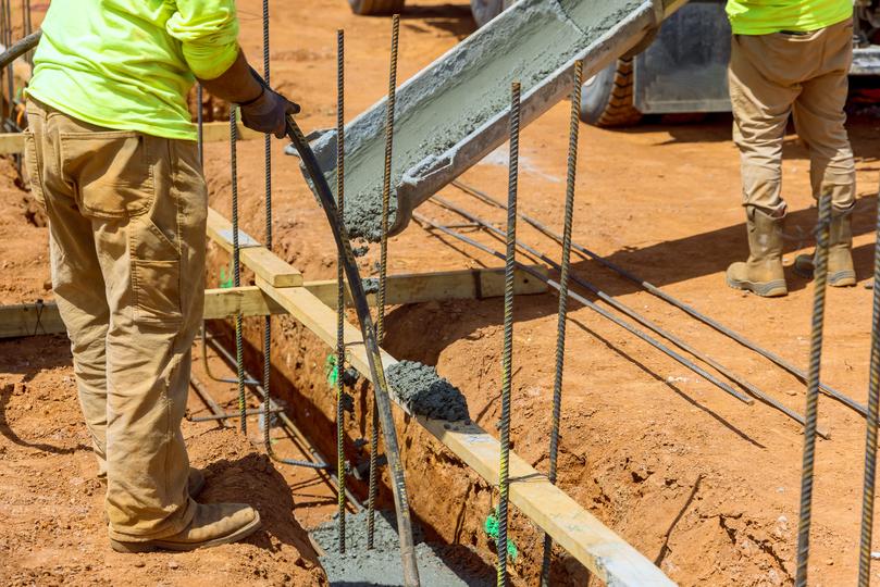 A Concrete truck pouring a foundation