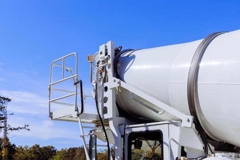 Volumetric concrete mixer preparing a custom mix on a construction site