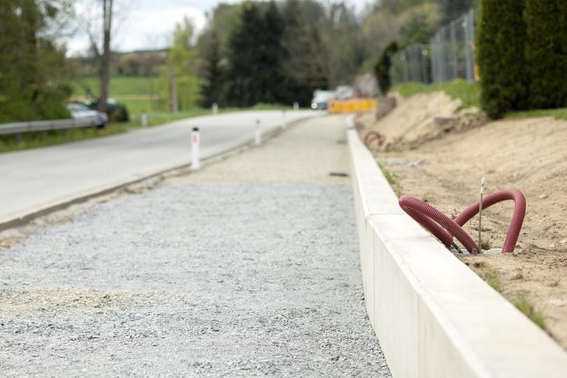 A newly installed concrete curb along a residential street