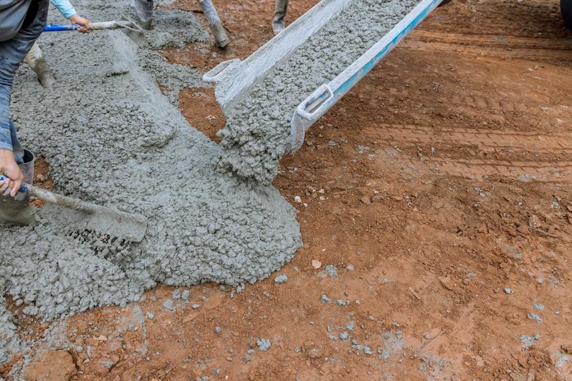 A Concrete truck pouring a foundation