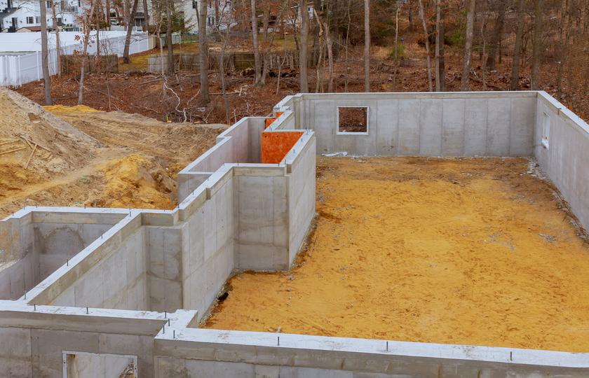 A concrete retaining wall in a landscaped garden