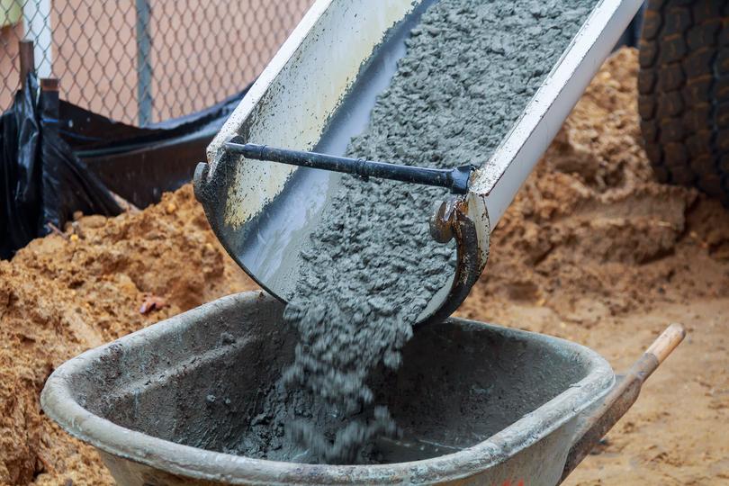 A Concrete truck pouring a foundation